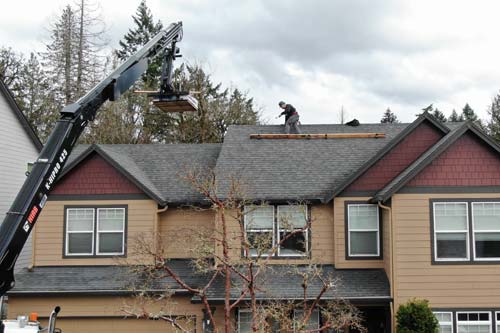 orange house siding and a crane